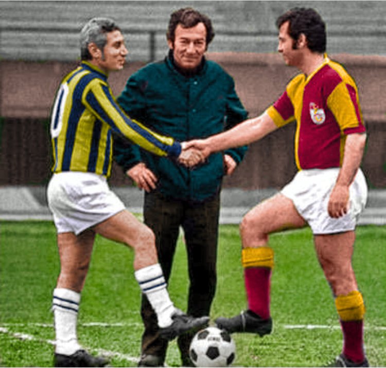 Lefter Küçükandonyadis and Metin Oktay shake hands at the centre circle before a match